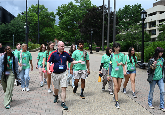A School pf pharmacy Admissions Counselor and prospective students on a campus tour along Academic Walk.