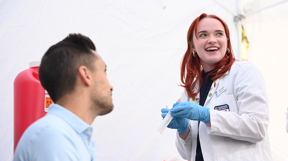 a student preparing to administer a vaccine