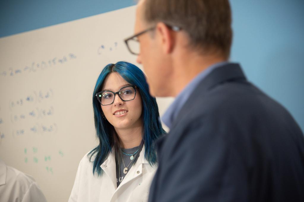 a girl talking to a professor