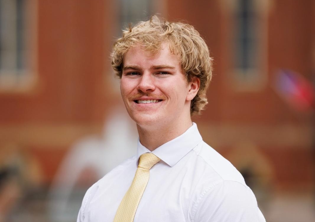 a male in a white shirt and tie
