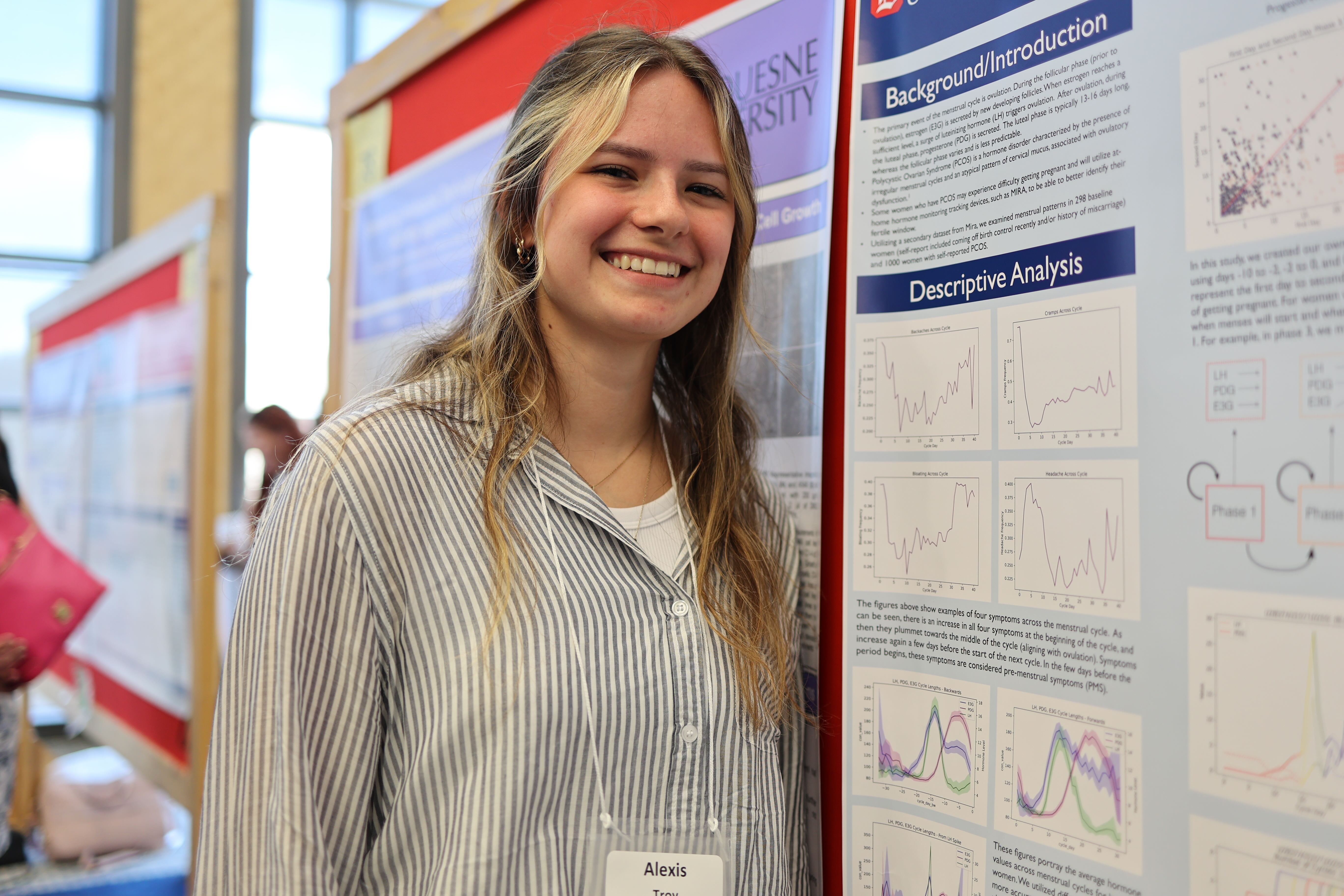 girl pointing to a poster