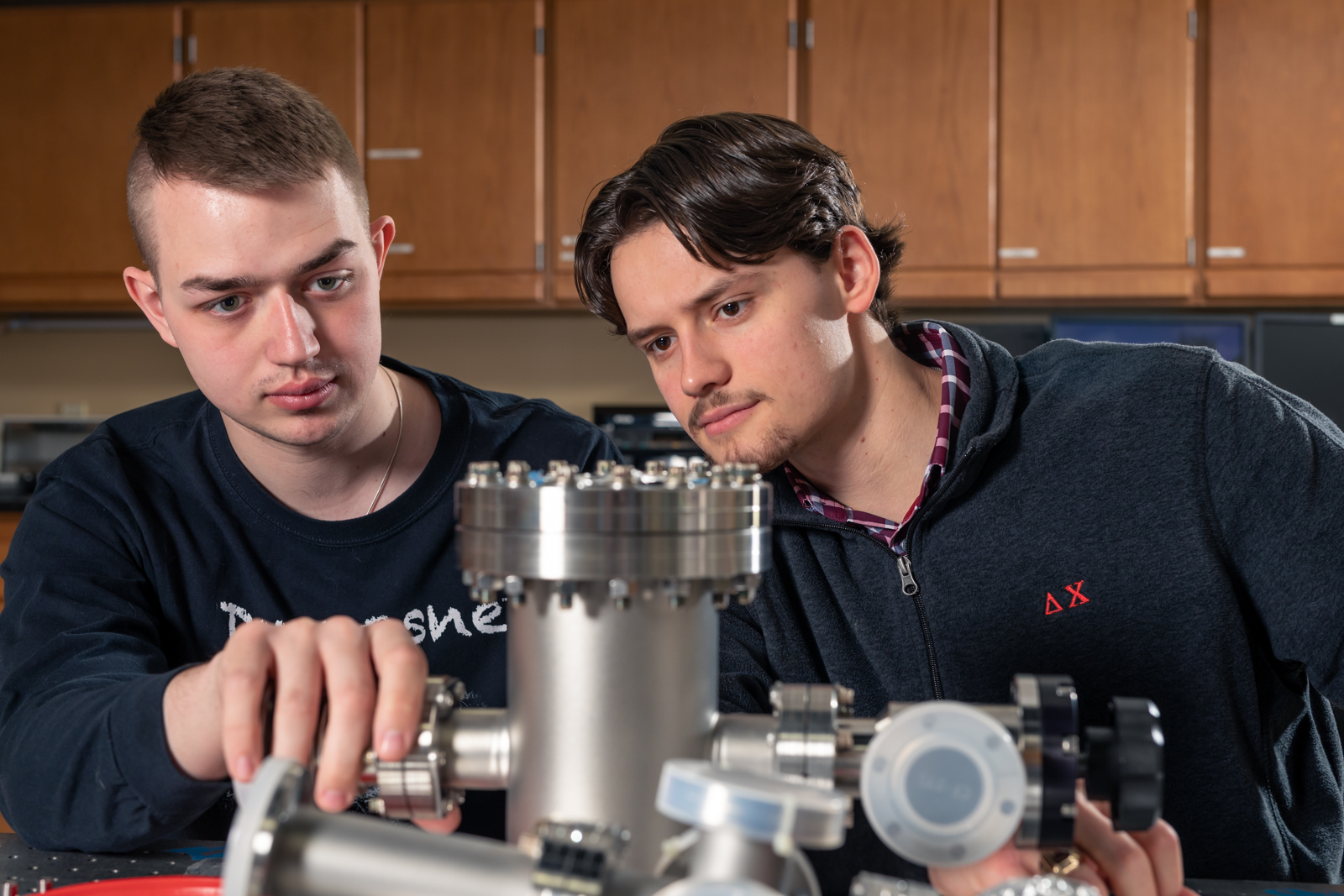 two males looking at equipment