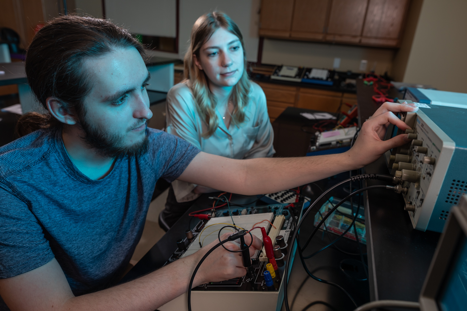 a male and a female student using a piece of instrumentation