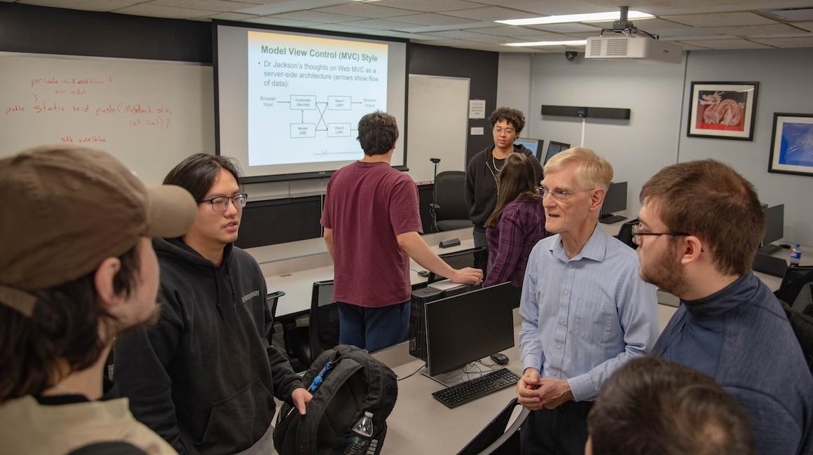 a group of people in front of a powerpoint