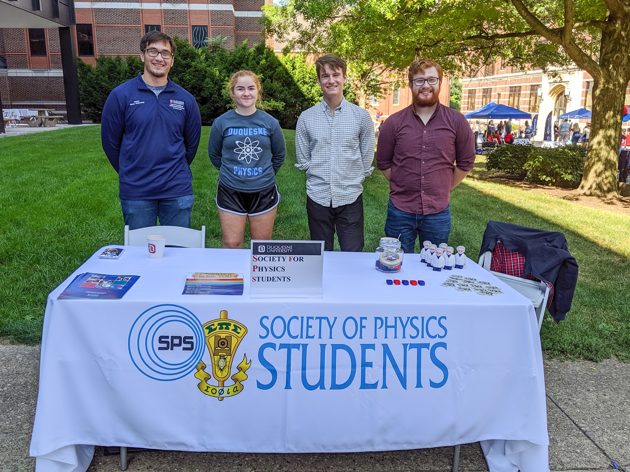 students standing in front of a table