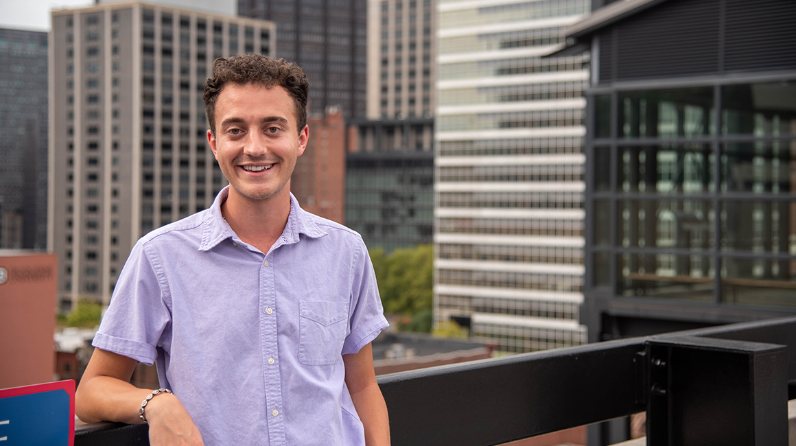 Pre-Law student Braden Niles at Duquesne with Pittsburgh skyline in the background 