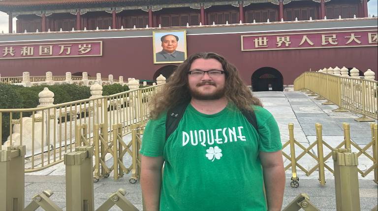 Deagan standing in front of a historical landmark 
