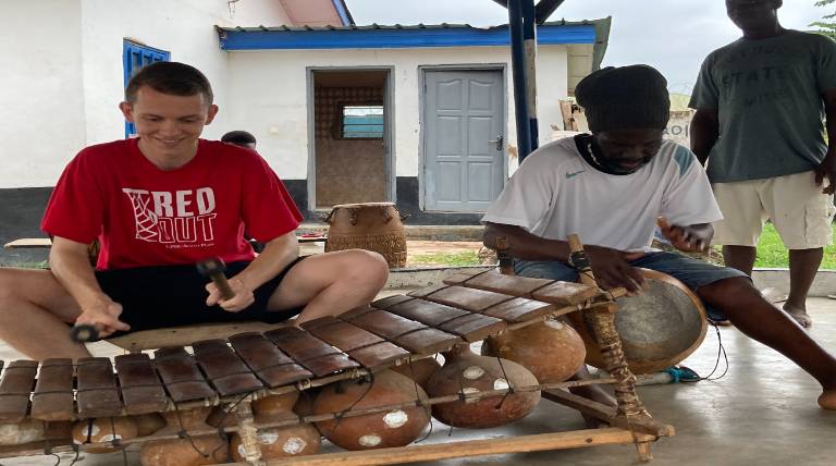 Gordon Cortney, an Endowed Honors Fellow, learning the gyil in Ghana.