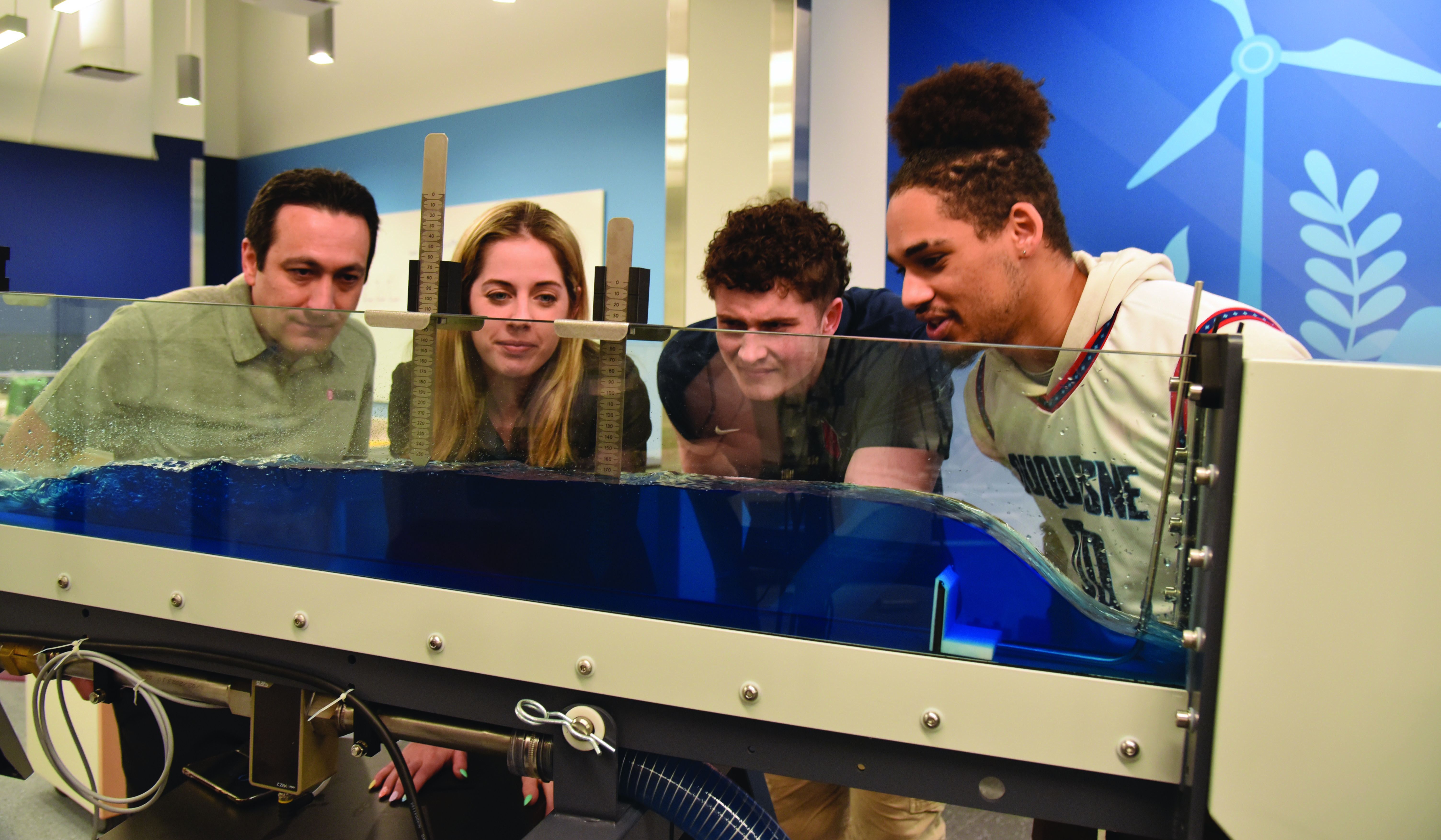 Engineering students look at equipment in Flume Room.
