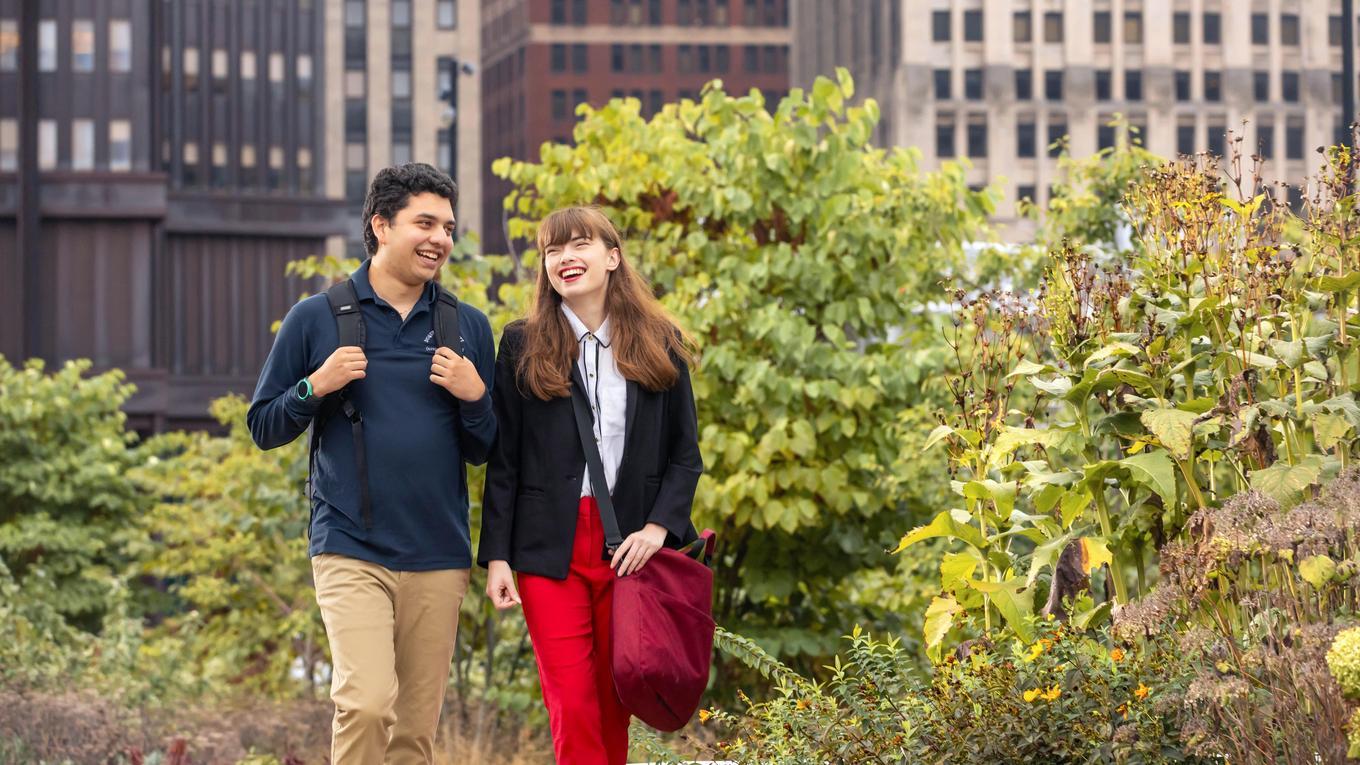 Two students walk together on campus.