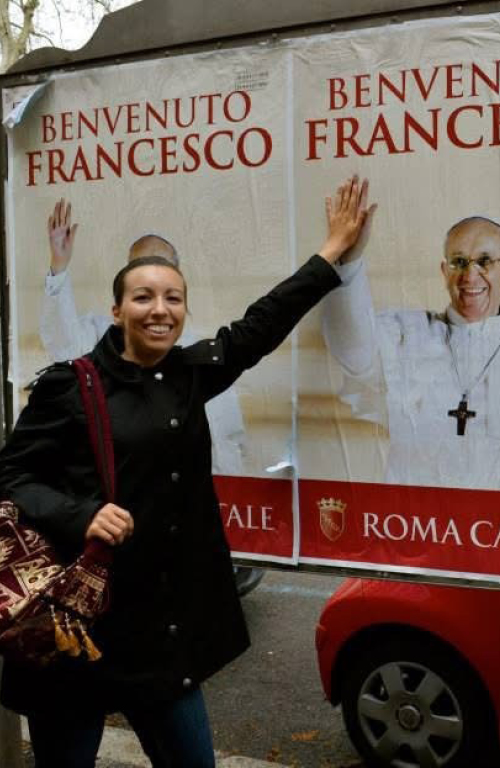 Jen Cardone high-giving Pope Francis on a poster.