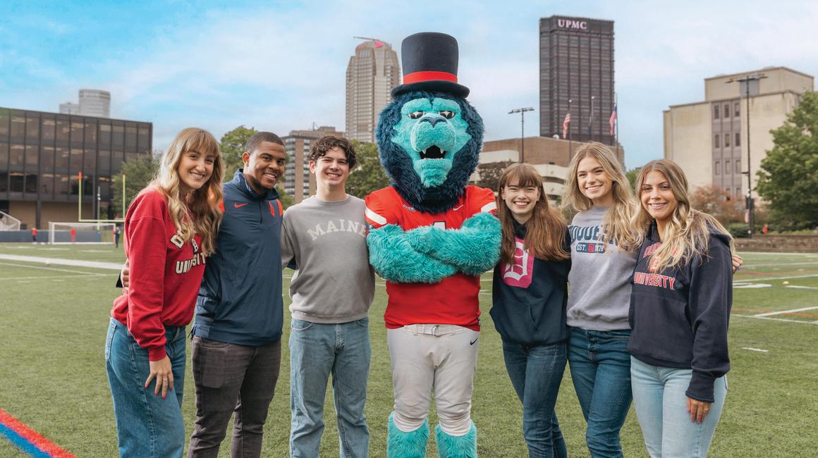 Duquesne students and mascot on Rooney Field.