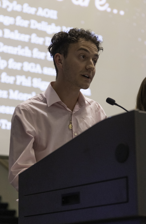 Duquesne student Braden Niles speaking at a podium on campus.