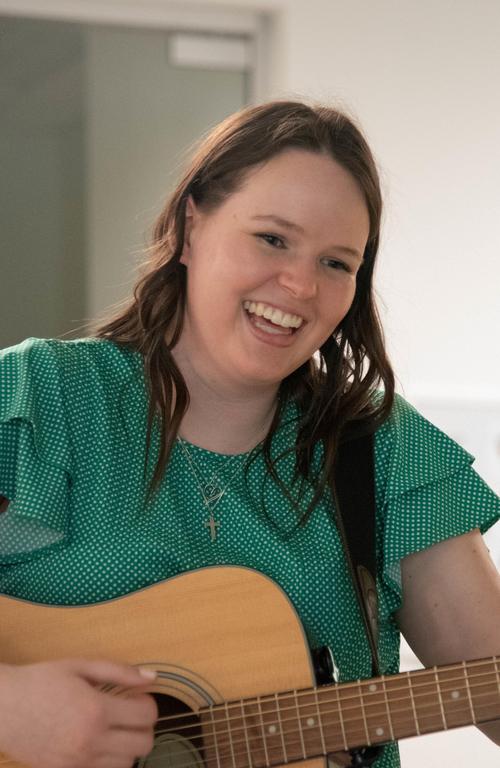 Rachel Anderson playing guitar at Children's Hospital