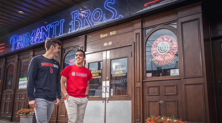 Duquesne students outside of the original Primanti Bros. in the Strip District.