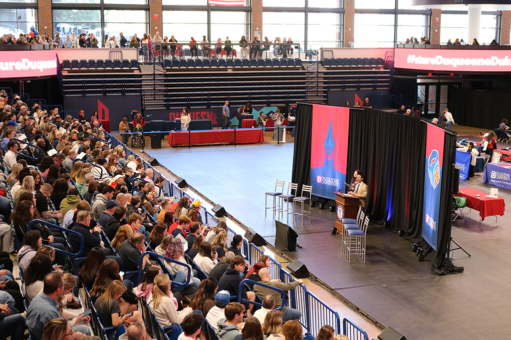 Students in Cooper Fieldhouse listening to speaker at Duq Day.
