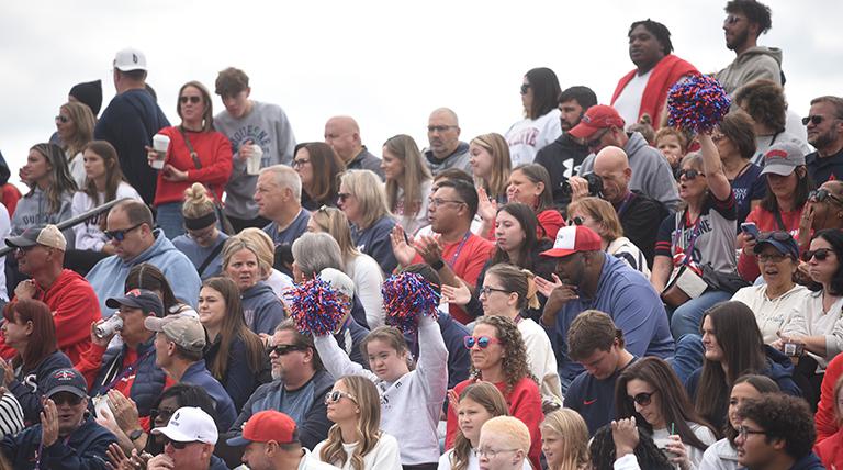 Crowd cheers on the Dukes at Homecoming football game