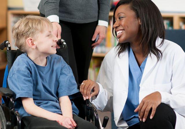 child with disability in wheelchair with female physician graphic