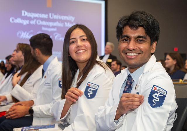 DO students showing off their new white coats