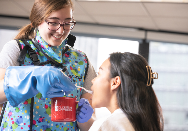 Speech-Language Pathology alumna Brooke Yurick interacting with a child.
