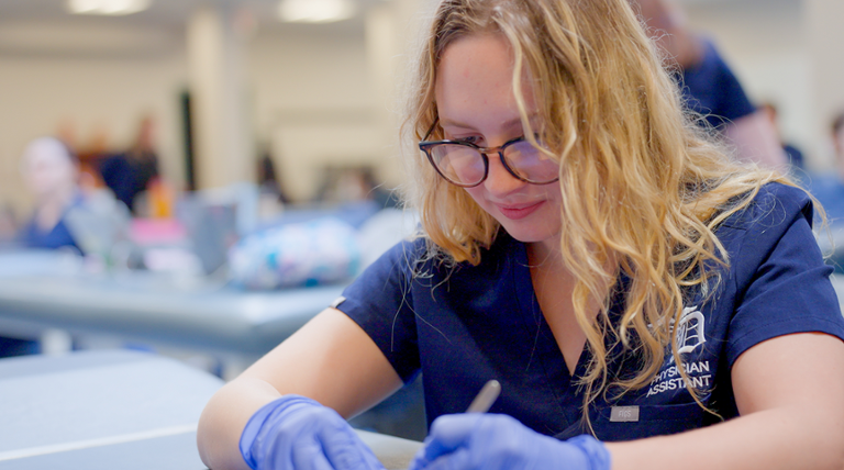 Physician Assistant student working in lab.