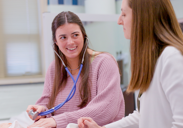 Two physician assistant studies students working in classroom