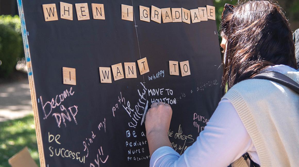 Student writing on chalkboard: "When I graduate, I want to..."