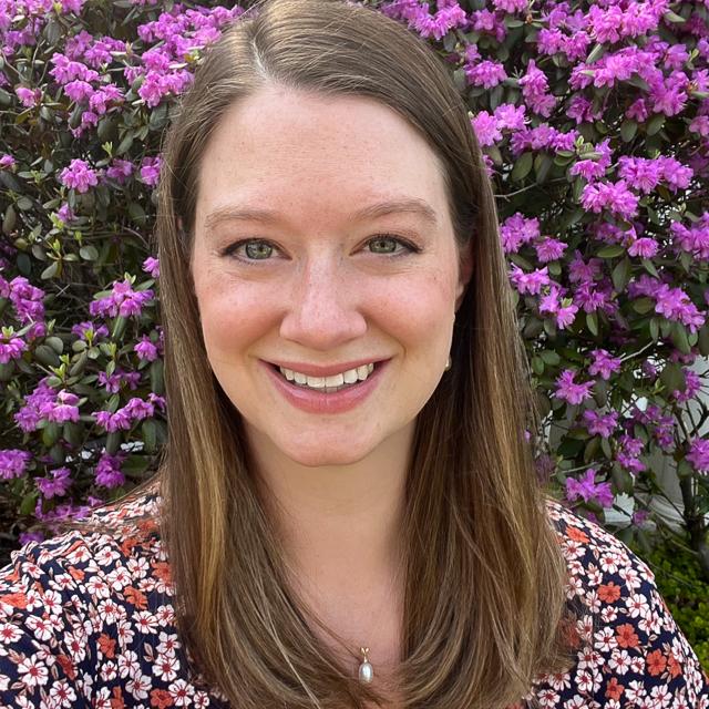 Photo of Dr. Kelsey Jones-Greer with flowers in background