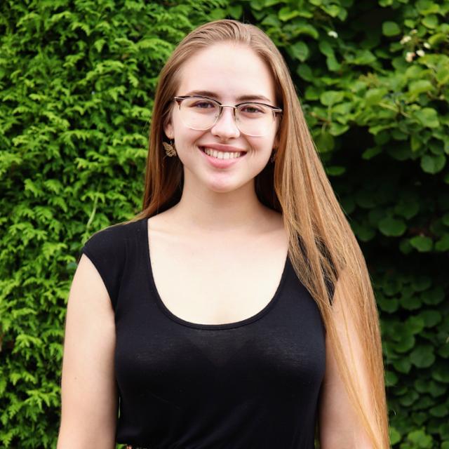 a girl in a black shirt with glasses