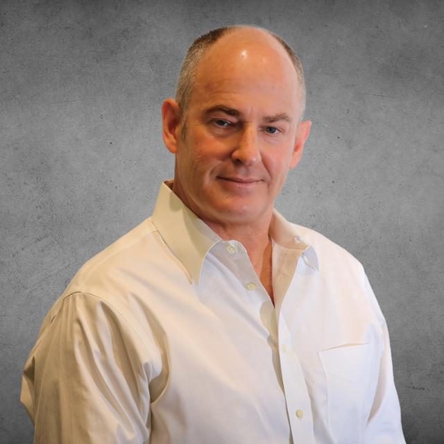 a picture of a male in a white shirt with a grey background