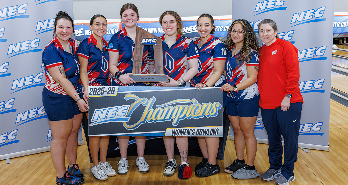 Womens bowling team and coach holding NEC trophy.