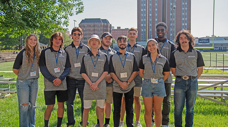 Duquesne's 2024-25 commuter assistants standing in front of the football field.