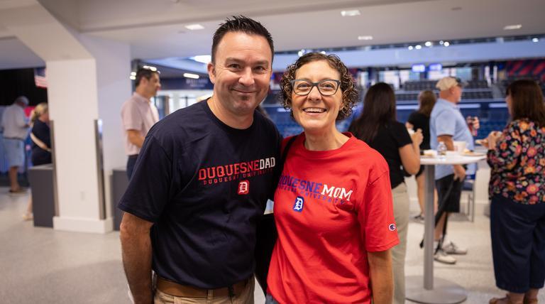 Two Duquesne parents in the UPMC Cooper Fieldhouse at a recent Parent and Family Orientation.
