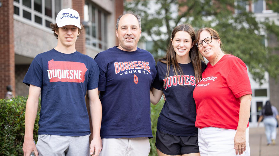 Family of 4 standing together at Move-In Day