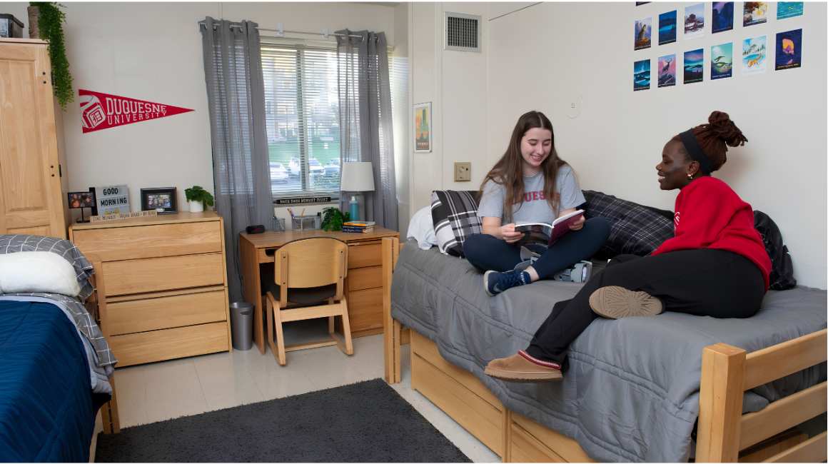 Two residents studying together in a residence hall