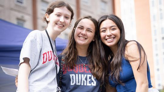 Three Duquesne students smile during orientation,
