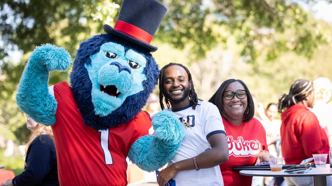 Students and staff pose with the Duquesne mascot.