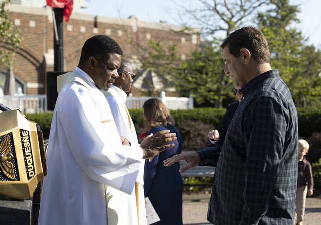 A person wearing their Duquesne University ring gets their ring blessed on during the ceremony on campus.