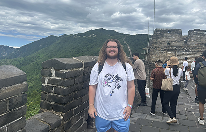 Deagan Moore stands in front of the Great Wall of China