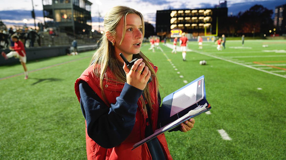 Kacie Garofalo works on the sidelines during a Duquesne football game