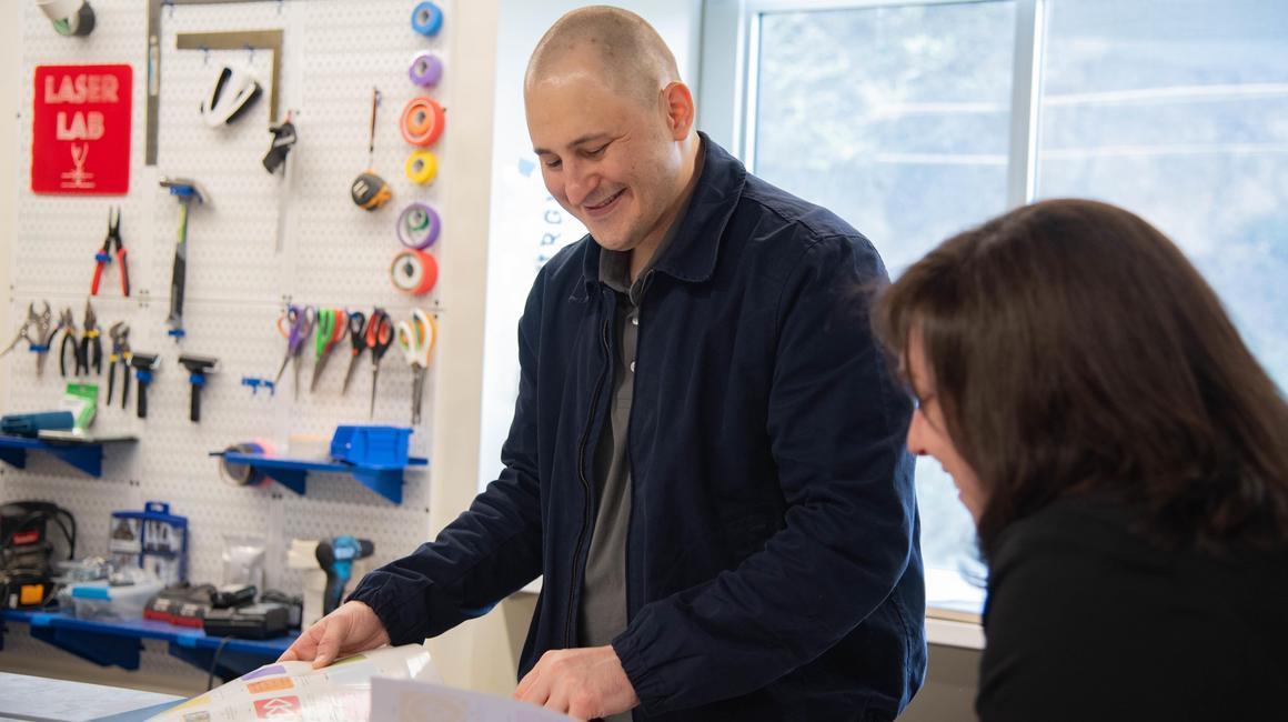 Luke Poljak chats with Staci Offutt in the Rockwell Hall makerspace.
