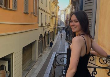 Catherine Startup standing on a balcony