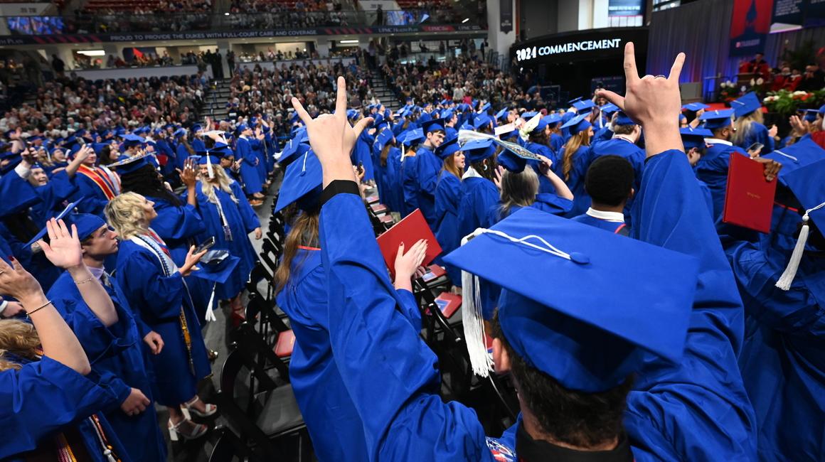 Graduate with hands in the air