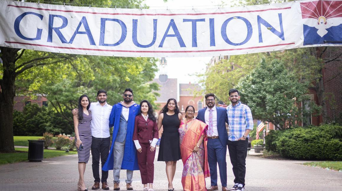 Family pictured in front of Graduation Banner