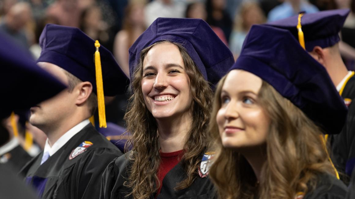 Seated female law graduate smiling