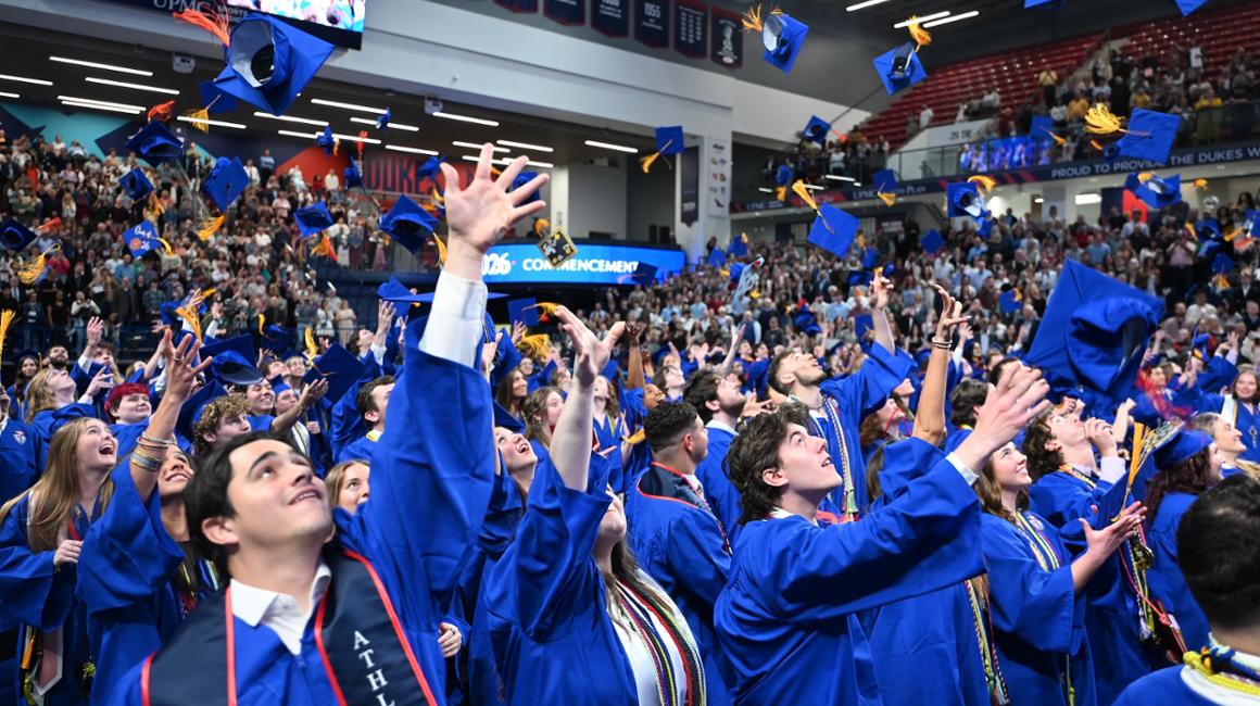 Graduates throwing their caps in the air