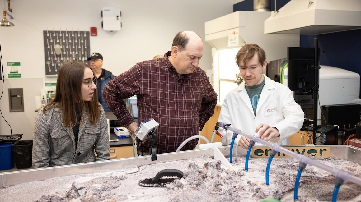 Students and professor at river simulation model