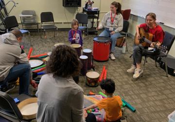 adults and children playing musical instruments