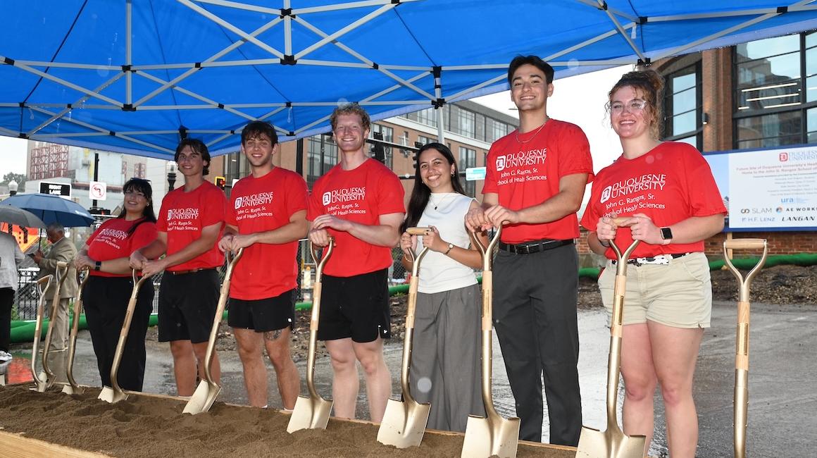 Students with shovels at groundbreaking event