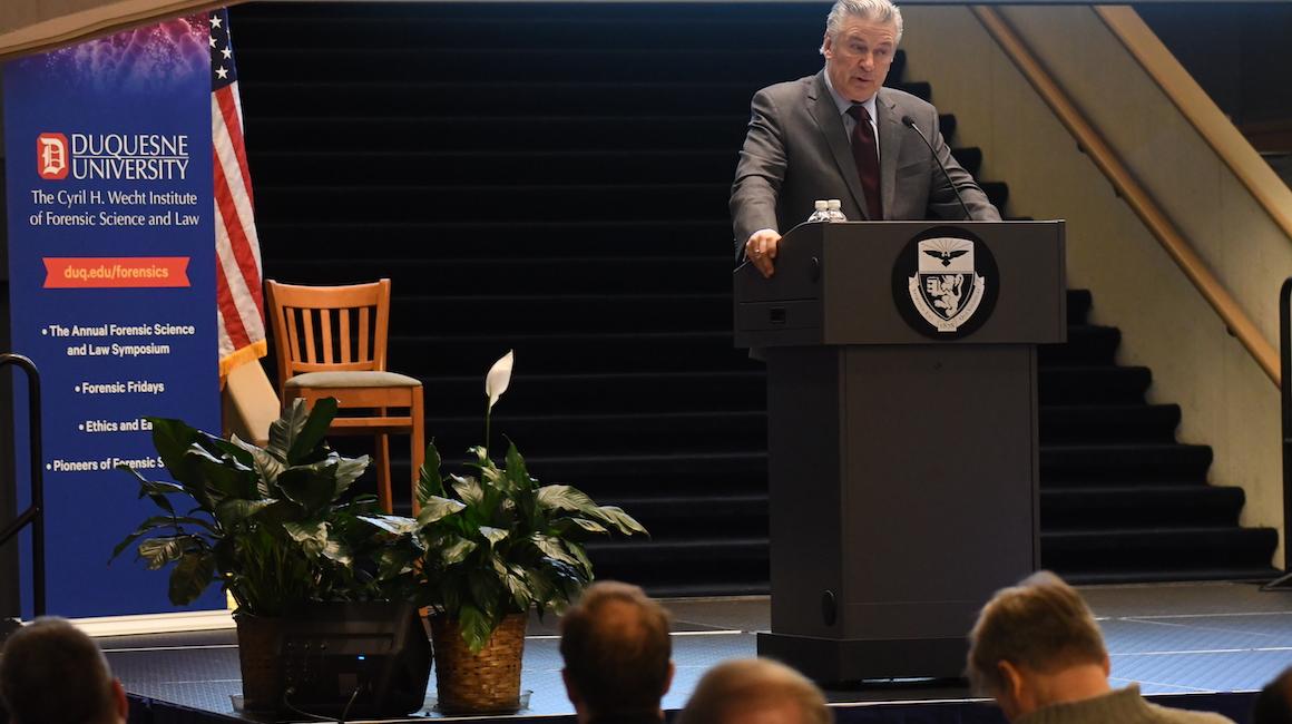 Alec Baldwin speaking at podium